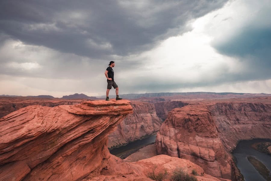 adventure man rock valley clouds photo unsplash