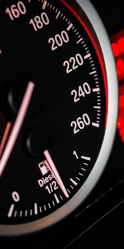 Close-up view of a car speedometer and fuel gauge. The speedometer shows a maximum speed of 260, and the fuel gauge indicates the tank is half full. The text "Diesel" is visible.