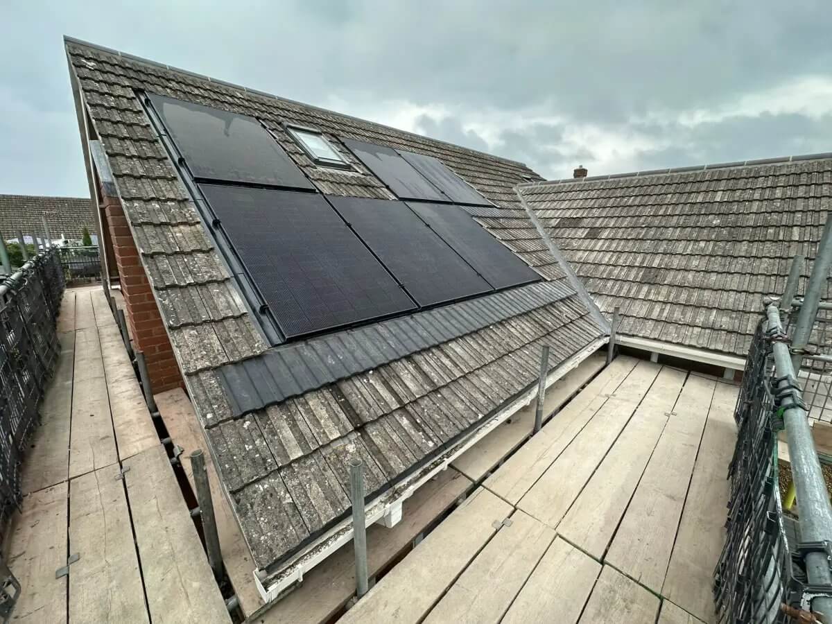 Full re-roof in progress — A completed tile roof with new ridge tiles
