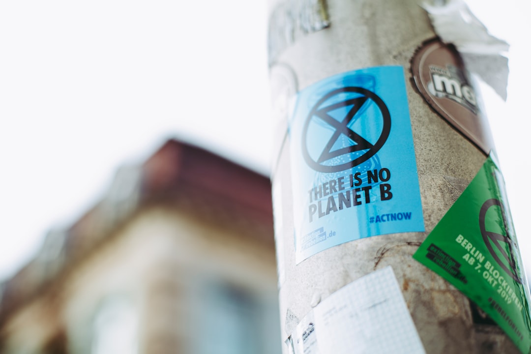 Close-up of a poster on a pole featuring the message "There is no Planet B" with an extinction symbol. Bath Digital Marketing Agency