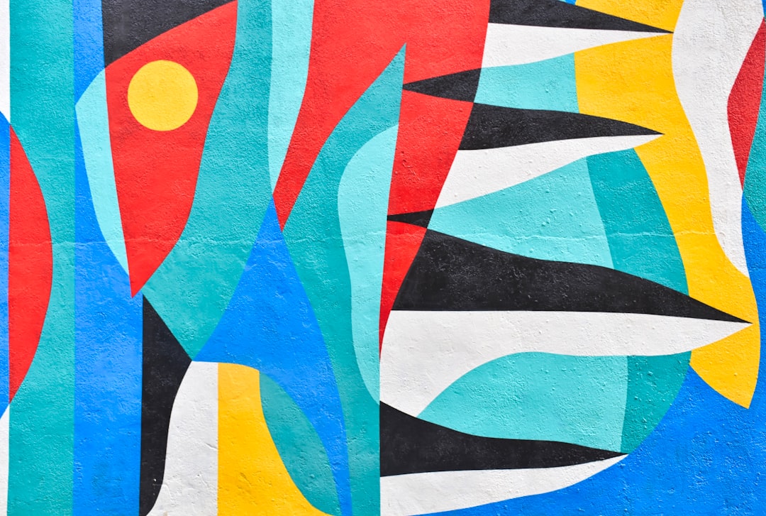 Vibrant abstract mural featuring bold colours and geometric shapes in red, blue, yellow, and black. Bath Digital Marketing Agency