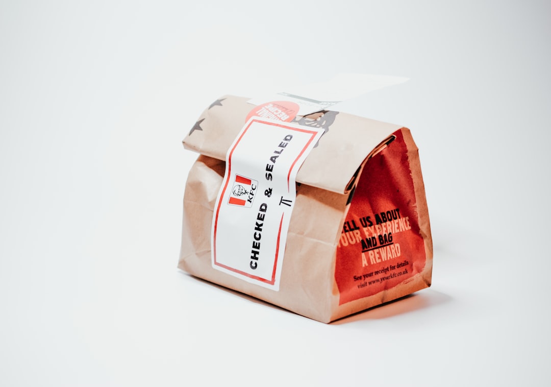 Wrapped takeaway container with a seal label, showcasing a simple and modern packaging style. Bath Digital Marketing Agency