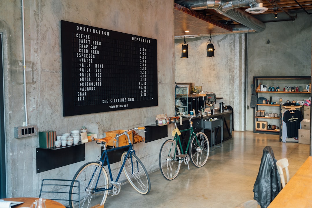 A modern café interior with a menu board, two bicycles on a shelf, and a stylish counter in the background. Bath Digital Marketing Agency