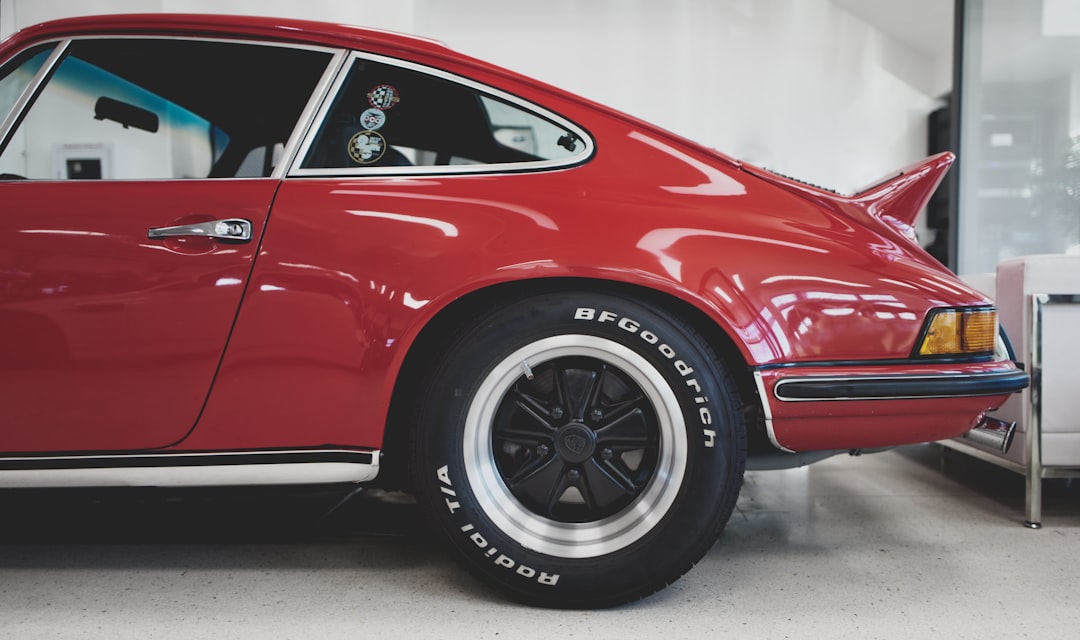 Side view of a classic red Porsche 911 with distinctive curves and black alloy wheels. Bath Digital Marketing Agency