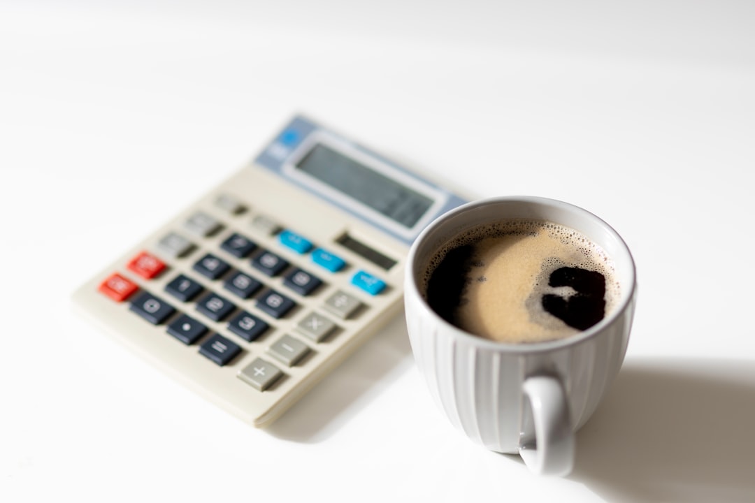 Calculator next to a cup of coffee, highlighting a workspace or study setting. Bath Digital Marketing Agency