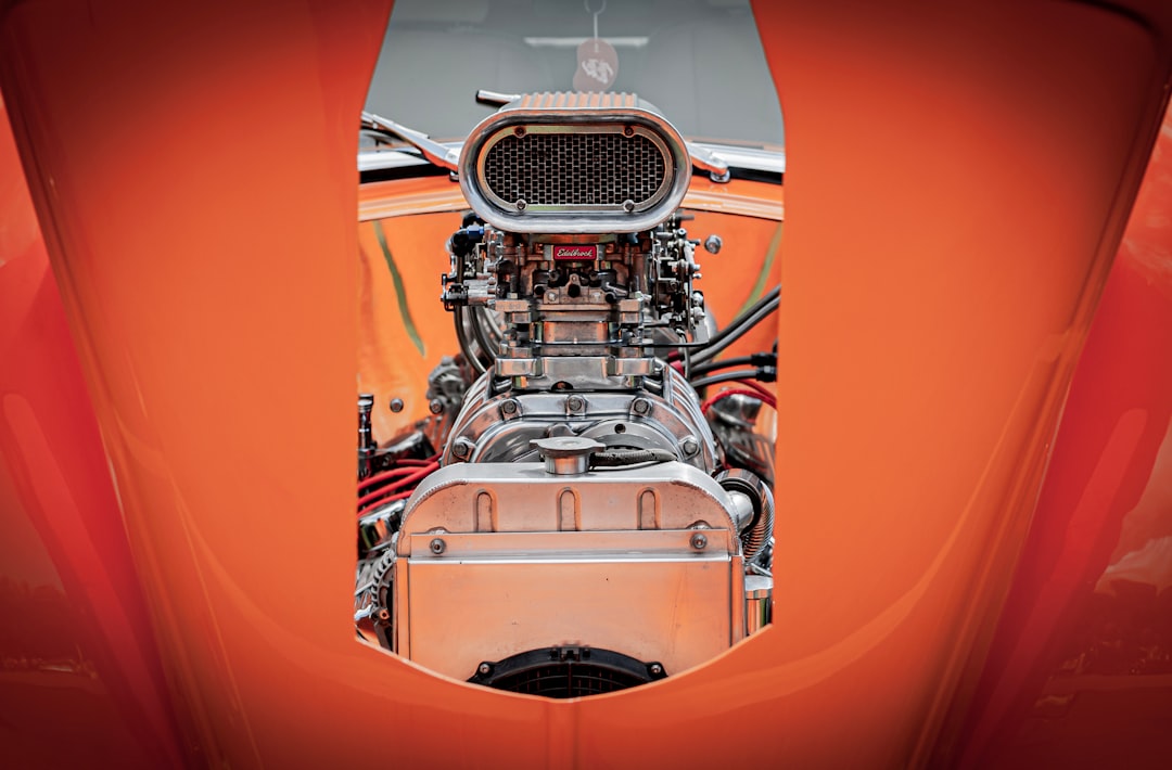 A close-up view of a powerful engine inside a car, showcased through an opening in the bodywork. The shiny chrome components and intricate details highlight the engineering and performance aspect of the vehicle. Bath Digital Marketing Agency