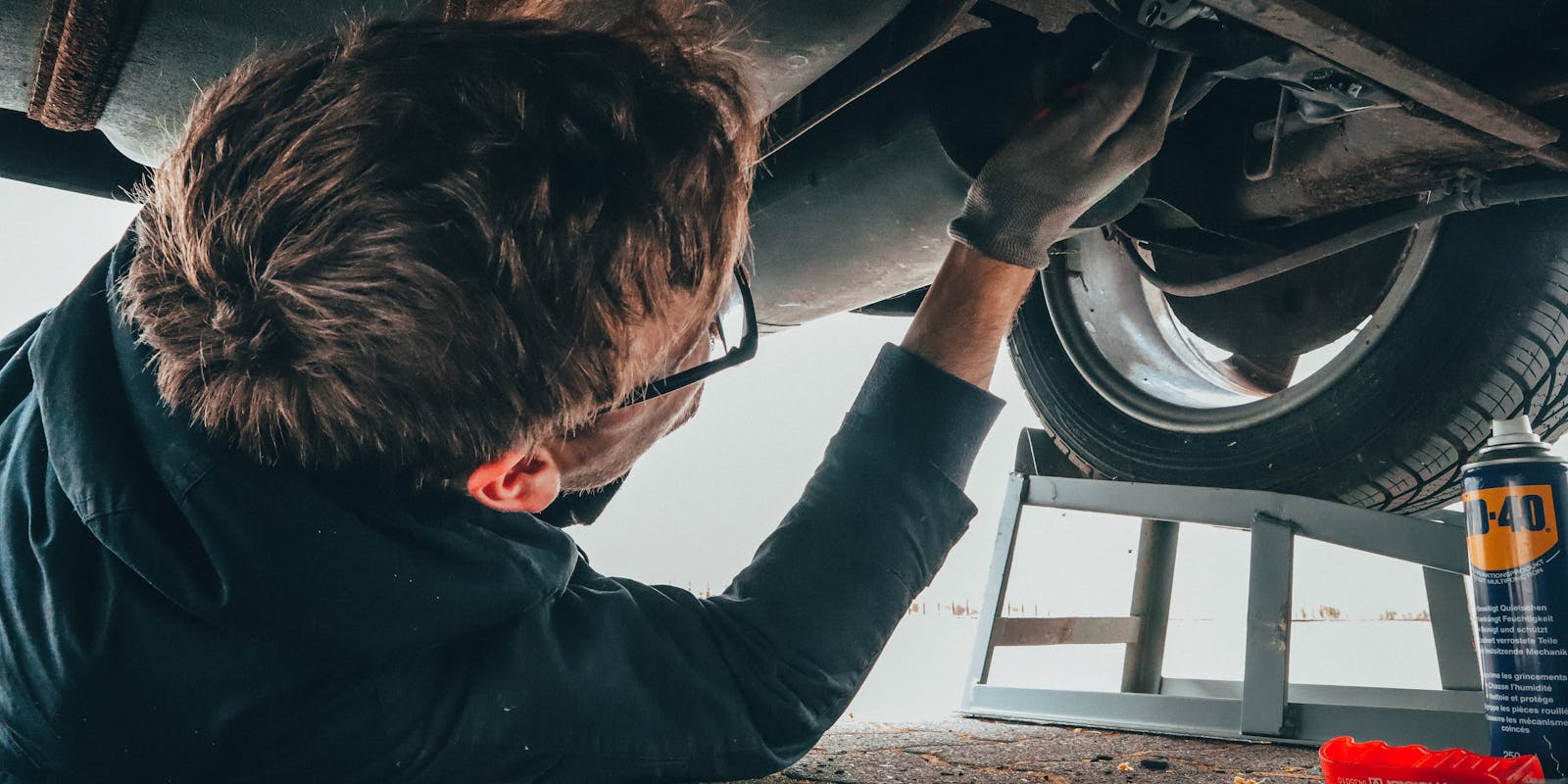 man working on car engine