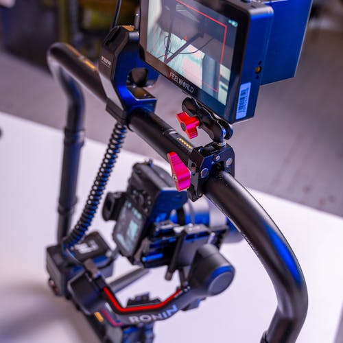 Hand holding black machined steel mechanical pencil with brass tip and top.