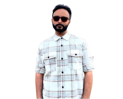 Wood table with porcelain mug, leather journal, brass pen, leather key ring, and a houseplant.
