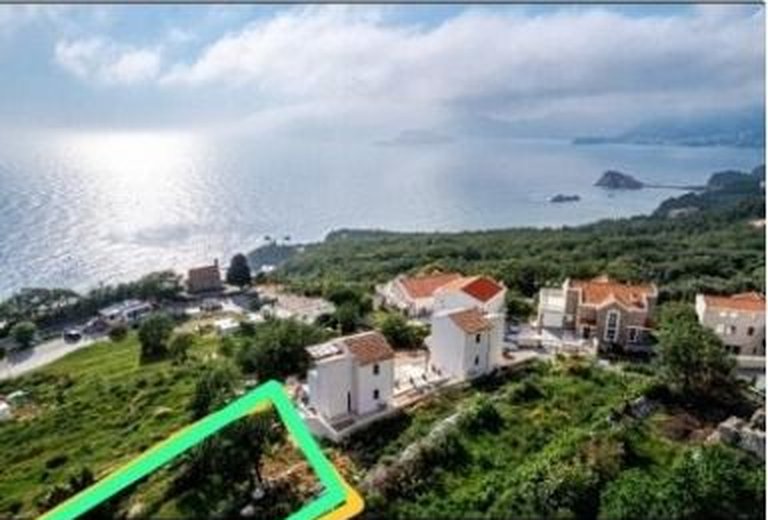 Aerial photo of a green hillside building plot above the sea near Sveti Stefan, with the plot outlined and nearby houses