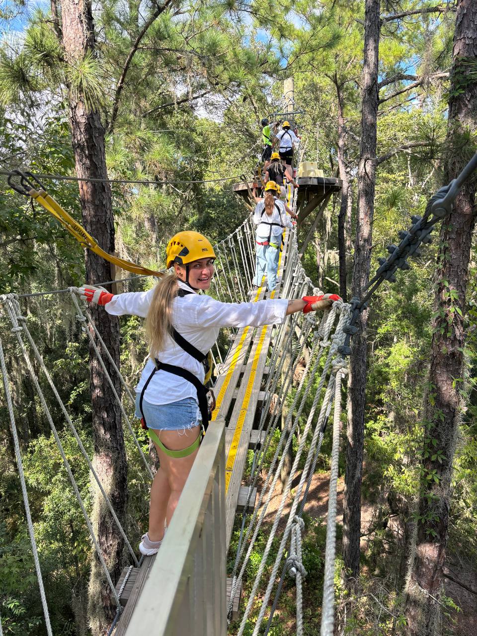 Hand holding black machined steel mechanical pencil with brass tip and top.