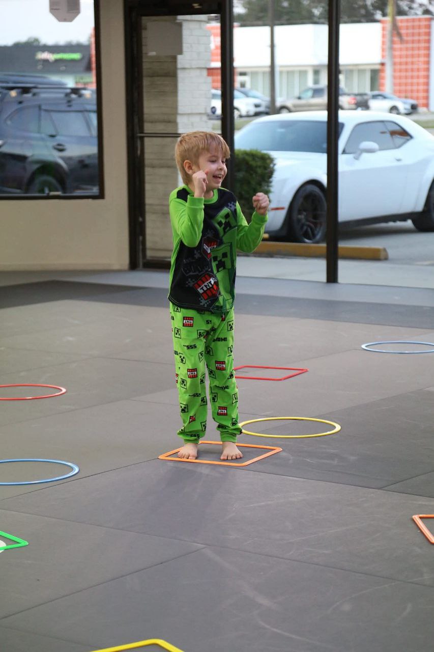 Two each of gray, white, and black shirts laying flat.
