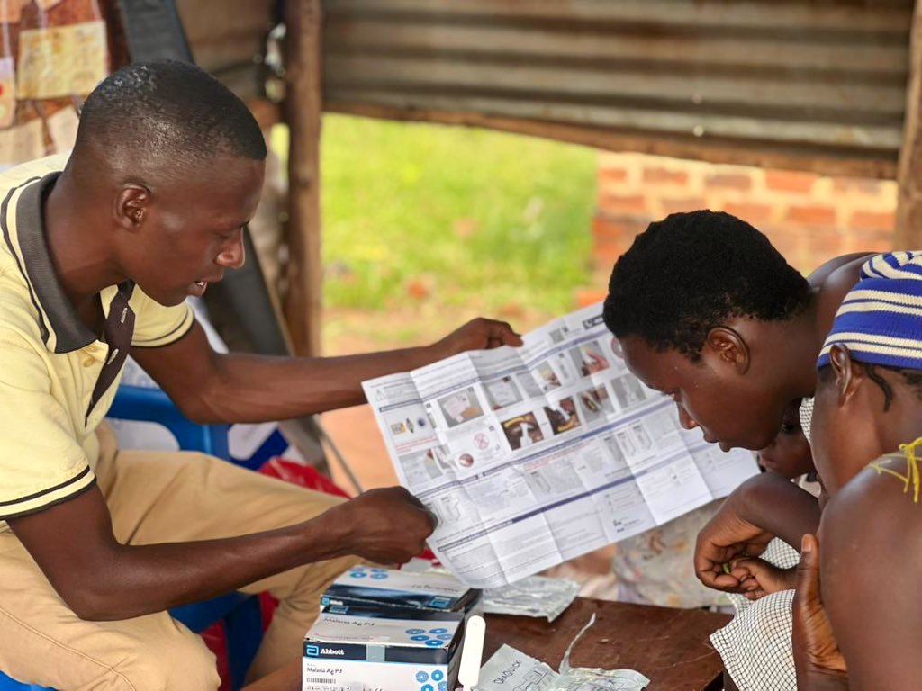 Hand holding black machined steel mechanical pencil with brass tip and top.