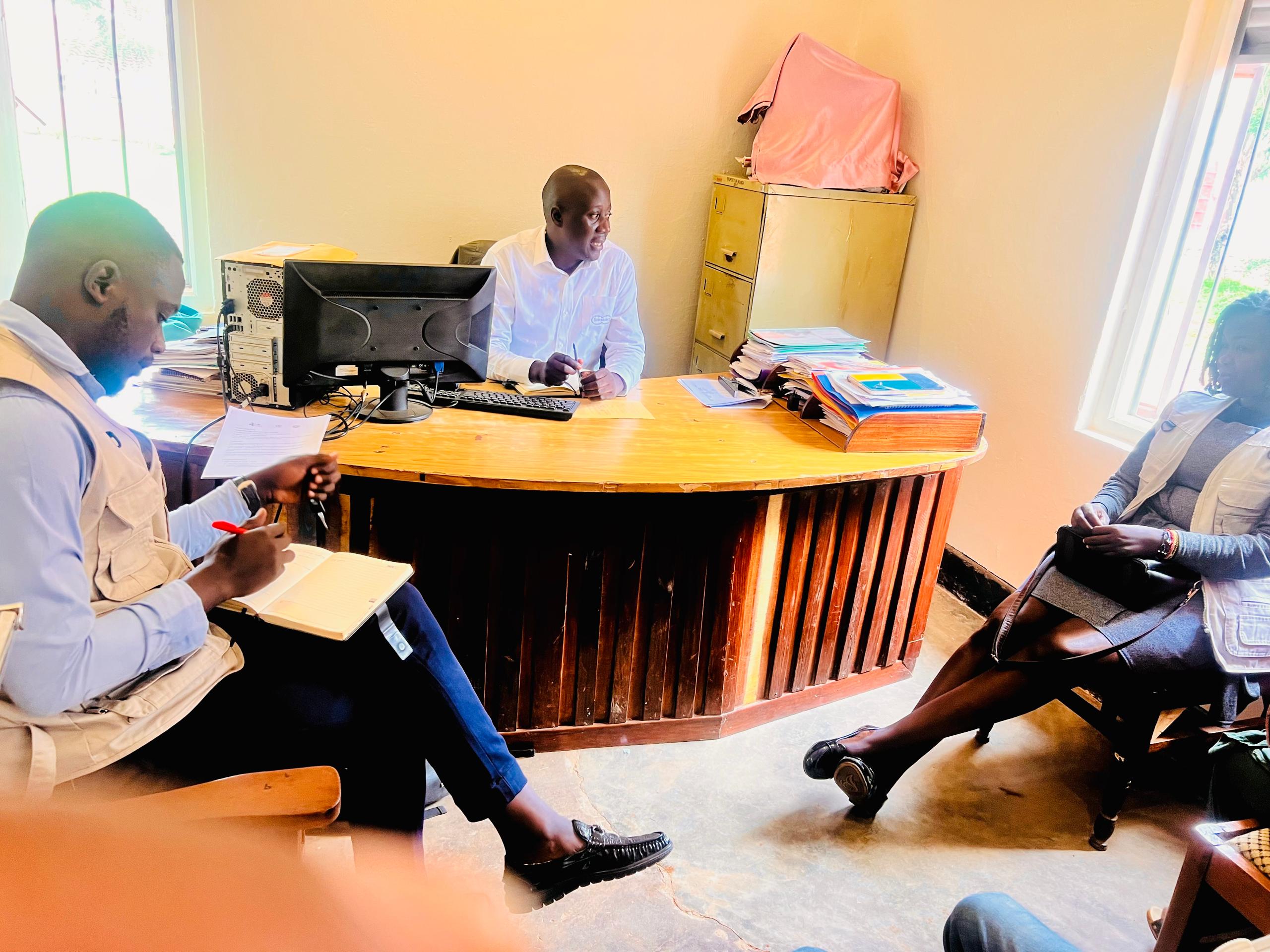 Tall slender porcelain bottle with natural clay textured body and cork stopper.