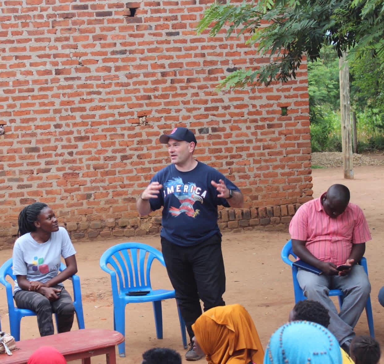 Hand holding black machined steel mechanical pencil with brass tip and top.