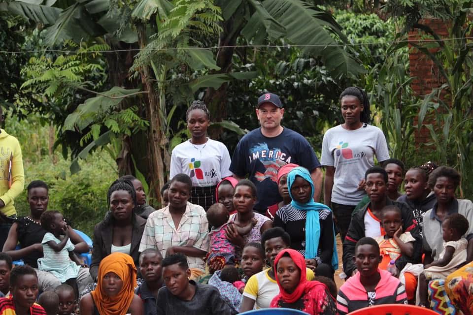 Tall slender porcelain bottle with natural clay textured body and cork stopper.