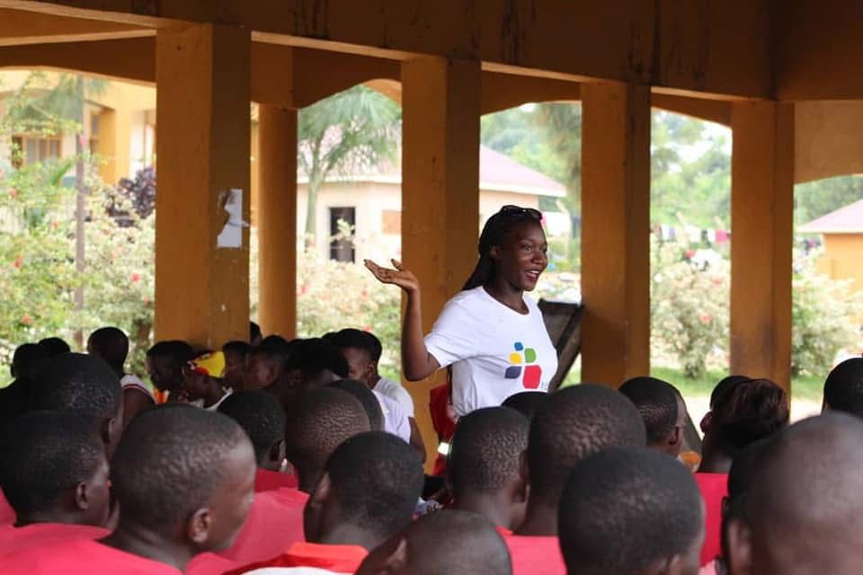 Person using a pen to cross a task off a productivity paper card.