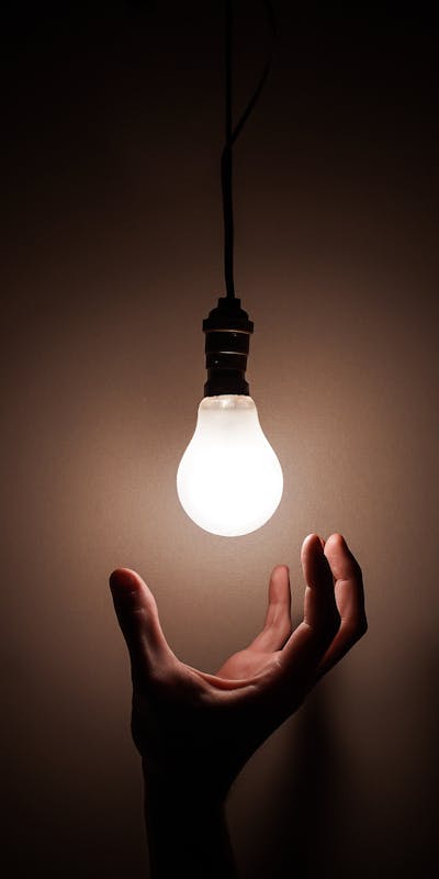 hand grabbing light bulb