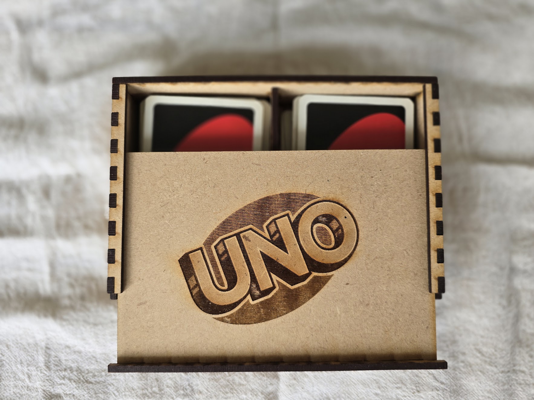 Hand holding black machined steel mechanical pencil with brass tip and top.