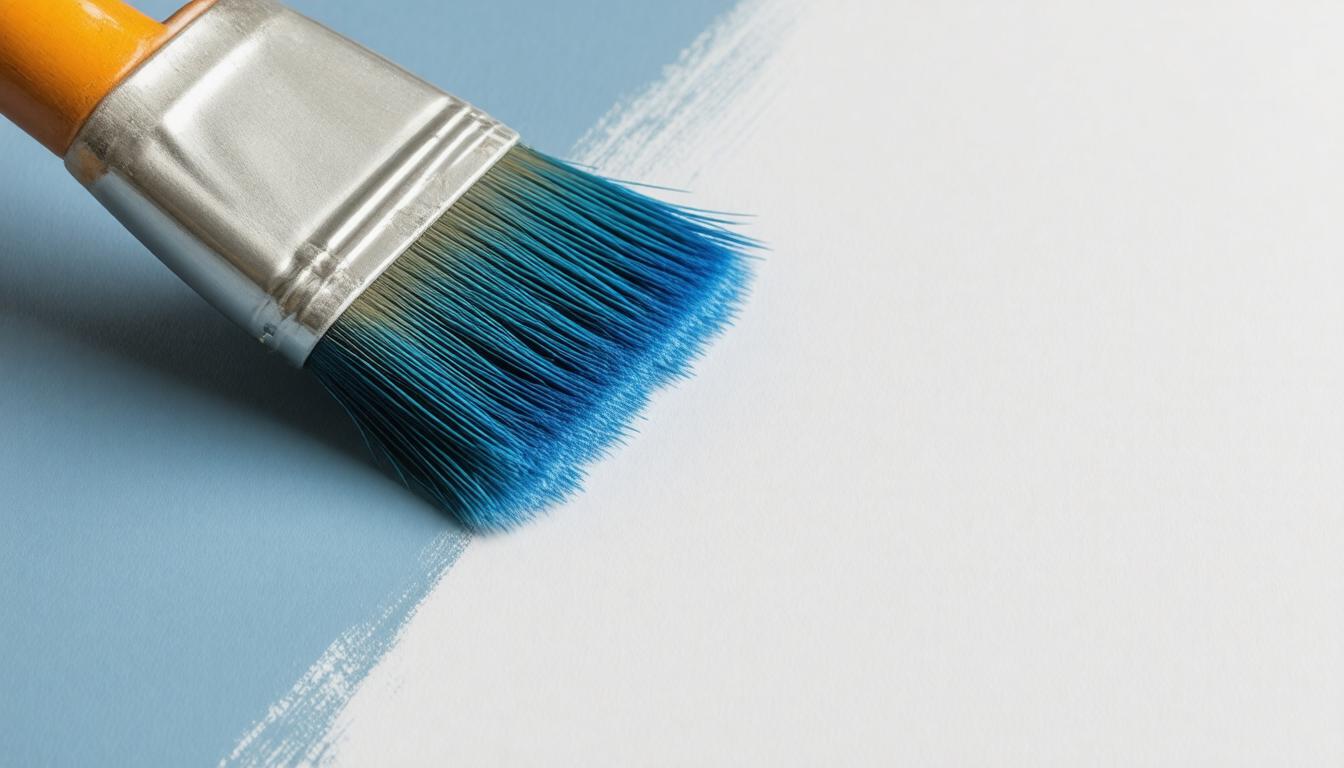 A paintbrush rests on a paint can against a blue wall, symbolizing creativity and home improvement.