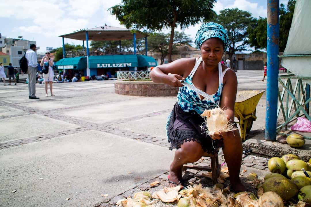 African Woman selling coconuts on the street in Santa Maria Sal island Cabo Verde - Is Cape Verde Safe, holiday safety and travel tips - Photo by Kristin Wilson | Cape Verde African Caribbean