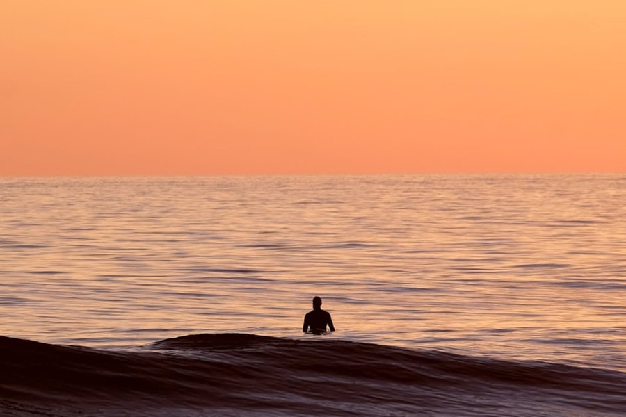 Lone surfer at sunset on Maio Cabo Verde islands – best surf spots to surf in Cape Verde on Holiday - Photo by Jason Zook | Cape Verde African Caribbean