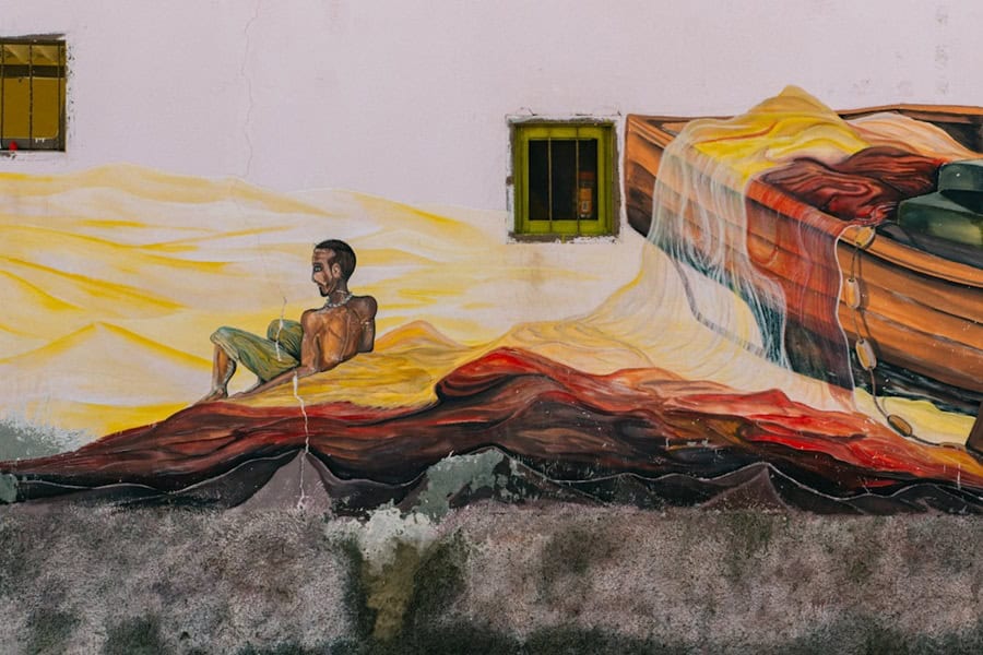 Mural of an African fisherman on a building in Mindelo Cabo Verde - Cape Verde Islands in Africa, History, Guide and Tips - Photo by Krisztian Tabori | Cape Verde African Caribbean