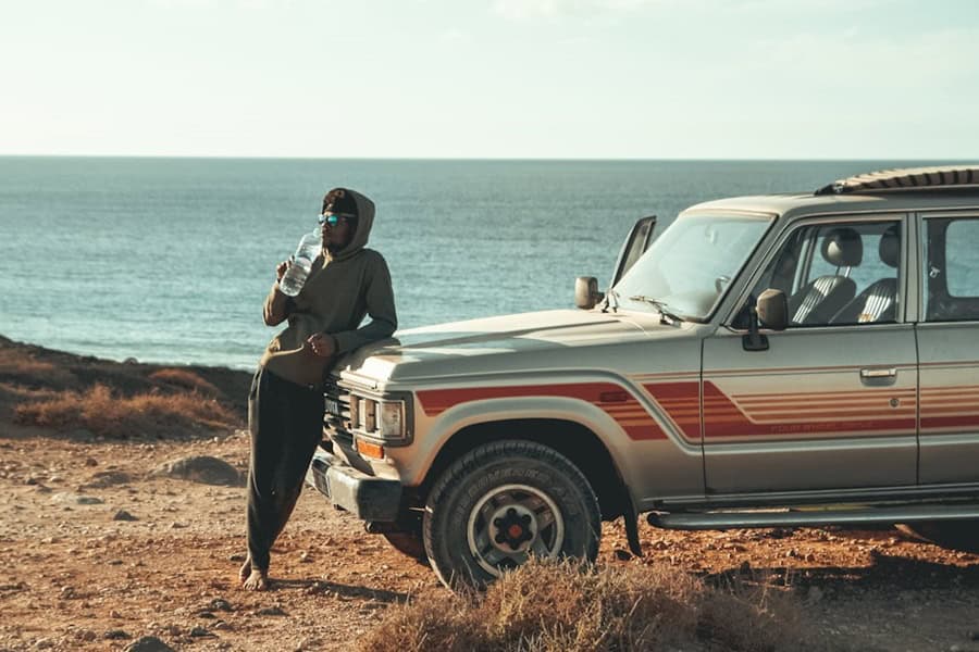 African surfer with 4x4 on Santiago Cabo Verde islands – best surf spots to surf in Cape Verde on Holiday - Photo by Eddy Billard | Cape Verde African Caribbean