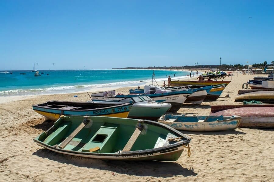 Colourful African fishing Boats on the beach in Santa Maria Cabo Verde - Cape Verde Islands in Africa, History, Guide and Tips - Photo by Florian K | Cape Verde African Caribbean 