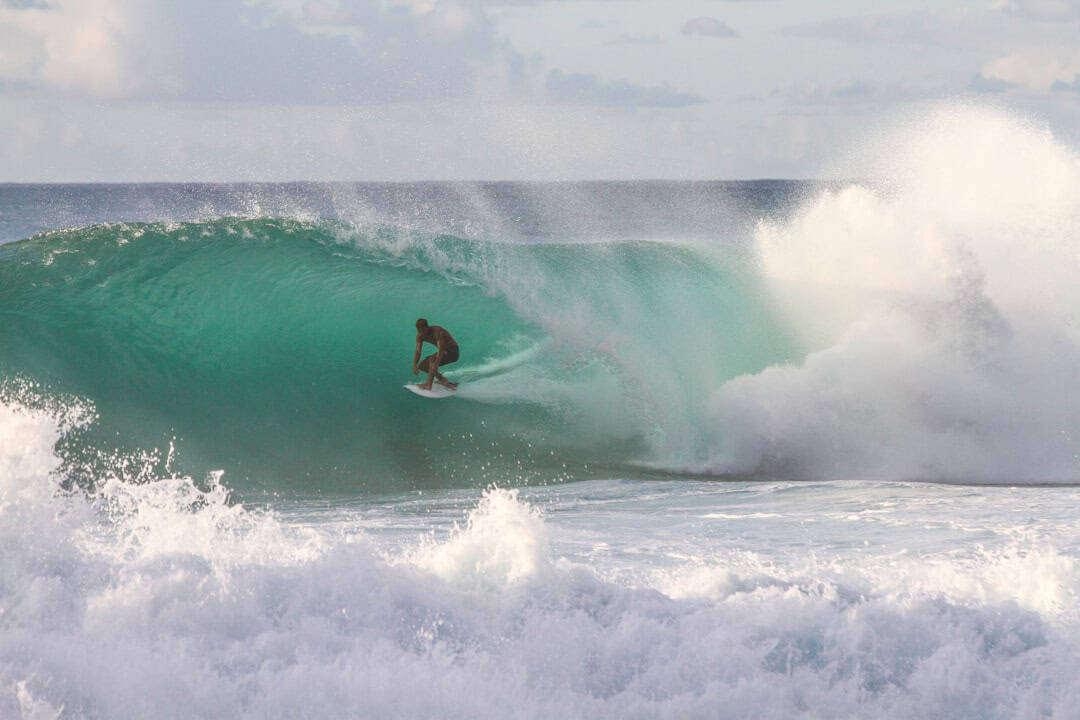 Surfer in the foaming water at Ponta Preta surfing Cabo Verde islands – best surf spots to surf in Cape Verde on Holiday - Photo by Jeremy Bishop | Cape Verde African Caribbean