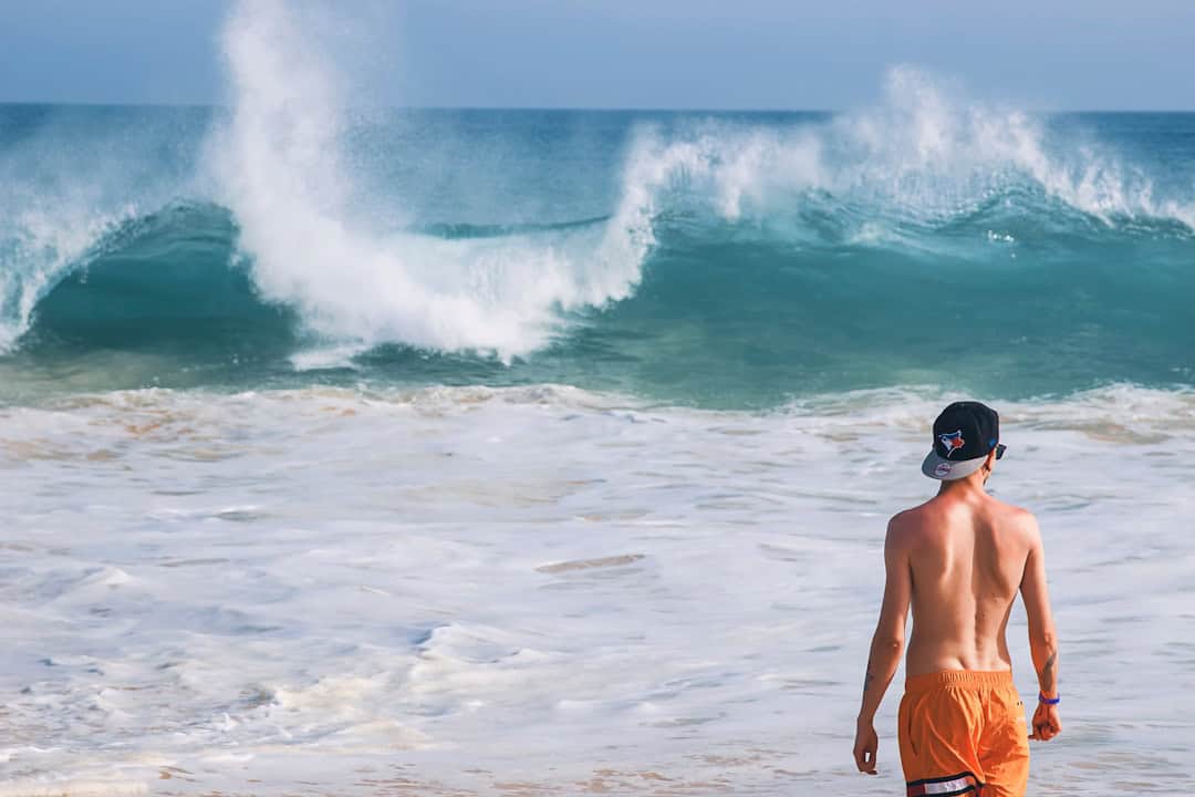 Tourist at the Santa Maria Beach with large wave Sal island Cabo Verde - Is Cape Verde Safe, holiday safety and travel tips - Photo by Katarzyna Urbanek | Cape Verde African Caribbean
