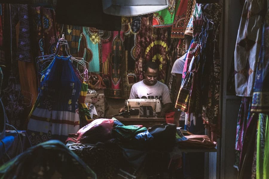 African Man in a shop making African fabric designs in Praia Cabo Verde - Cape Verde Islands in Africa, History, Guide and Tips - Photo by Danique Tersmette | Cape Verde African Caribbean