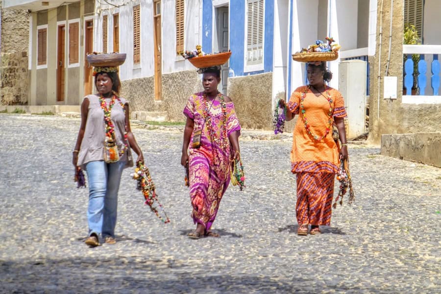 Three African women balancing baskets in Praia, Santiago Cabo Verde - Cape Verde Islands in Africa, History, Guide and Tips - Photo by Belinda Fewings | Cape Verde African Caribbean