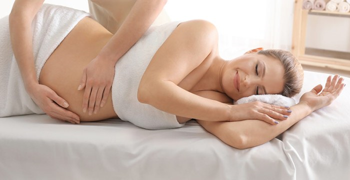 A pregnant woman lying on her side receiving a calming massage at ViyUla Beauty Spa in Darwin, designed to relieve discomfort and promote deep relaxation.