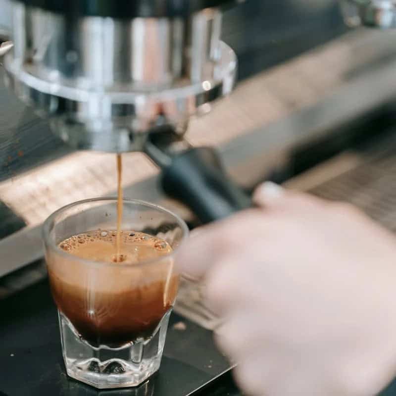 A shot of Beann Artisan Coffee espresso being pulled into a small glass - beann artisan coffee