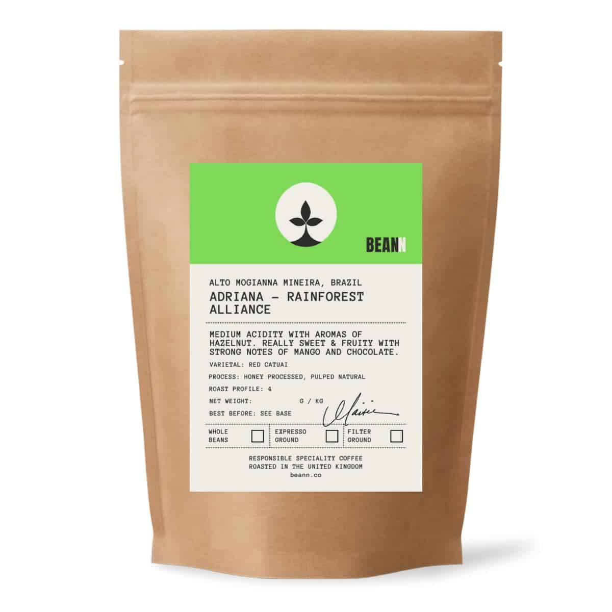 A brown paper bag of Bean brand coffee beans with a white and green product label - beann artisan coffee