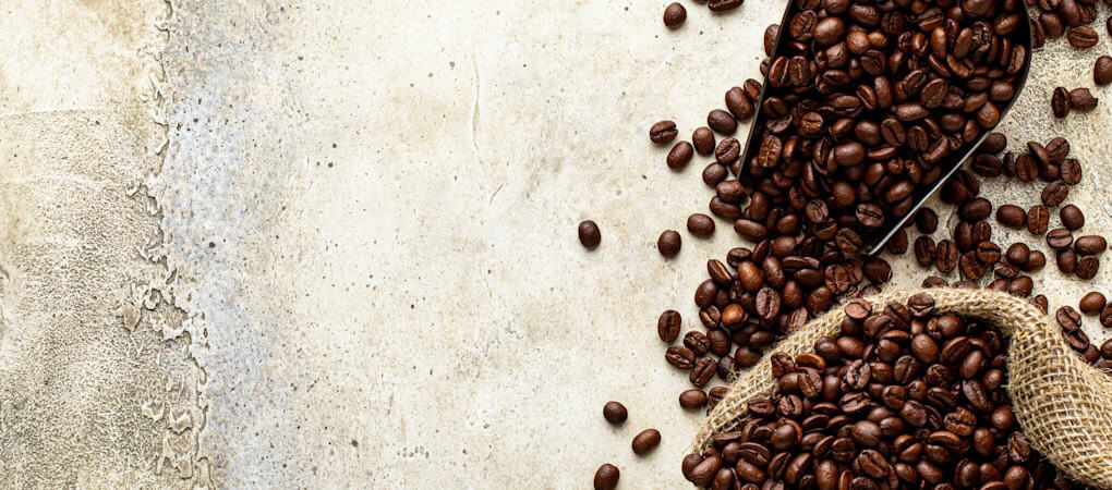 ark roasted coffee beans spilling from a burlap sack and scoop onto a rustic counter - beann artisan coffee