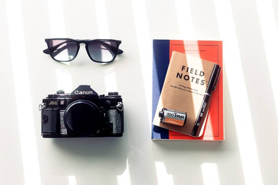 camera note pad glasses - Top Digital Product Consultancy Services - photo unsplash | de Paula Consultants
