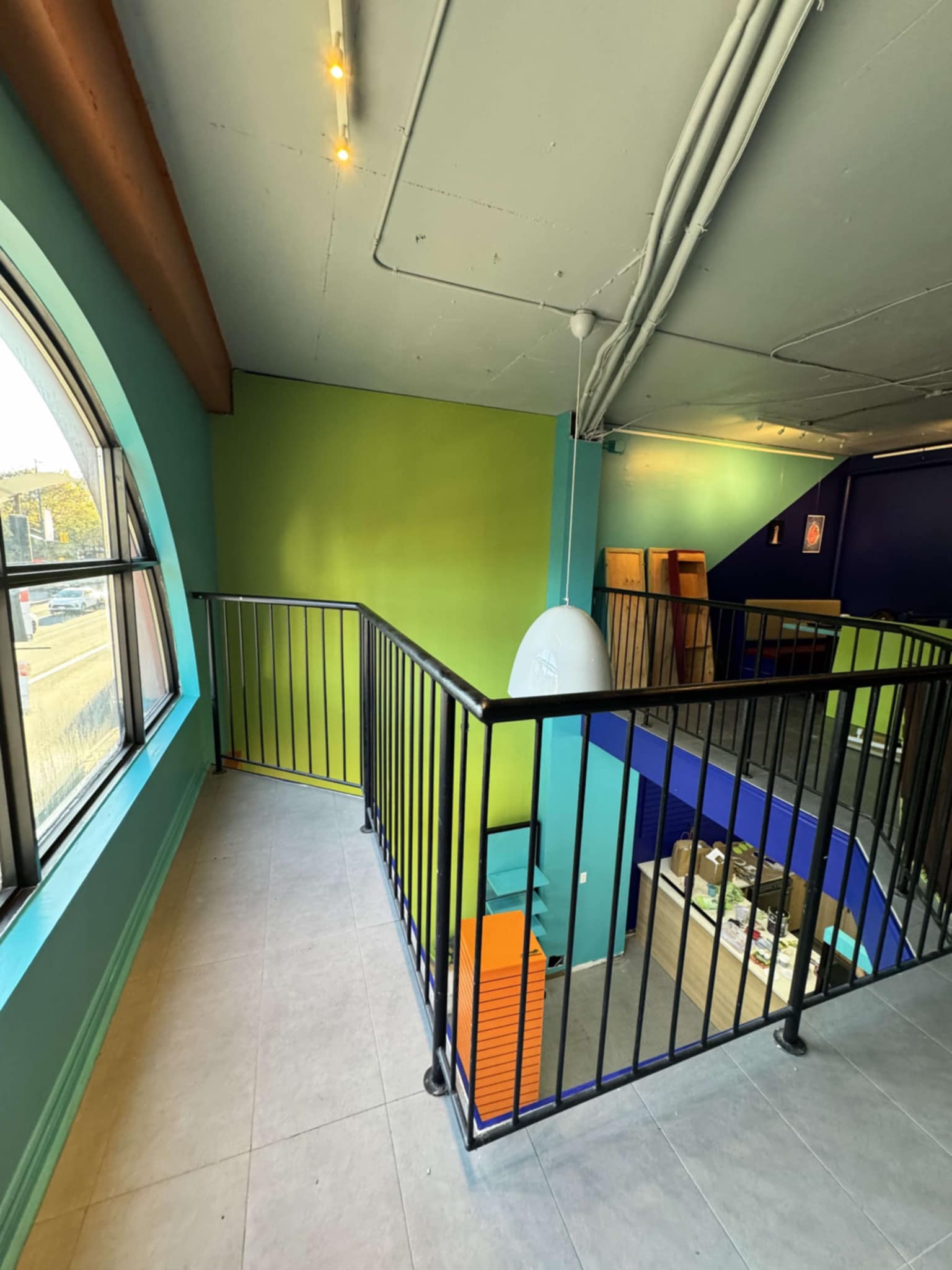 A photograph of a renovated industrial but fun looking space with funky colours 
