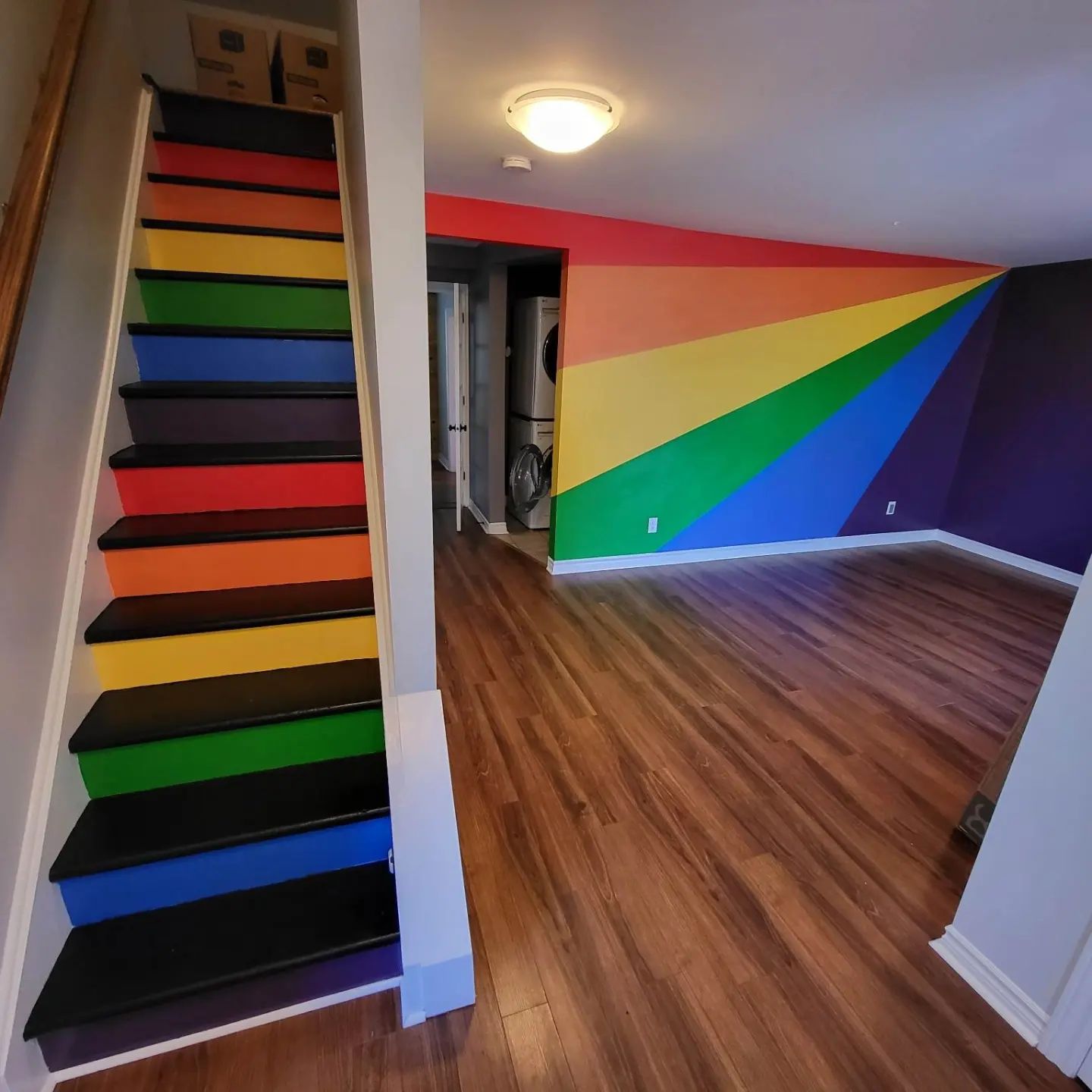 Rainbow painted staircase and living room wall