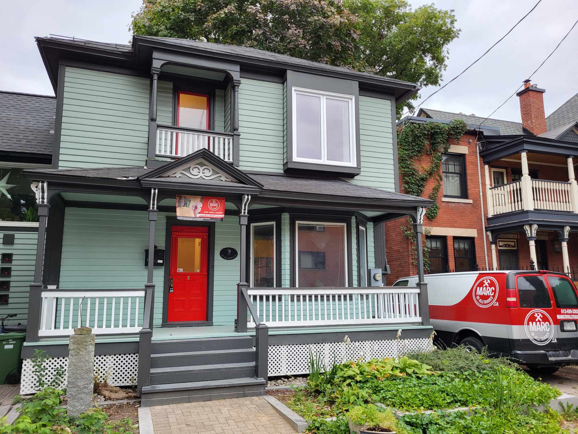 A freshly painted vintage classic home with a newly restored and renovated deck and awning
