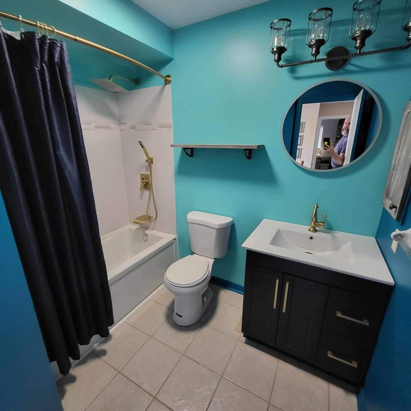 a photograph of a newly renovated modern looking bathroom with walls painted in eclectic colours