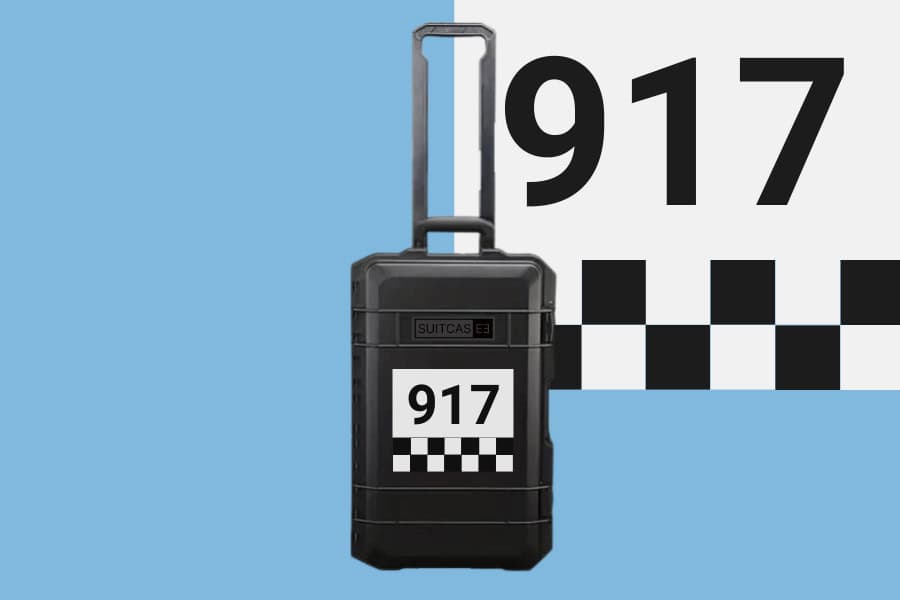 Artist Artwork SUITCASEƎ Racecar Porsche 917 Le Mans Waterproof Carry-On Suitcase designed for smooth rolling with vibrant chequered artwork.