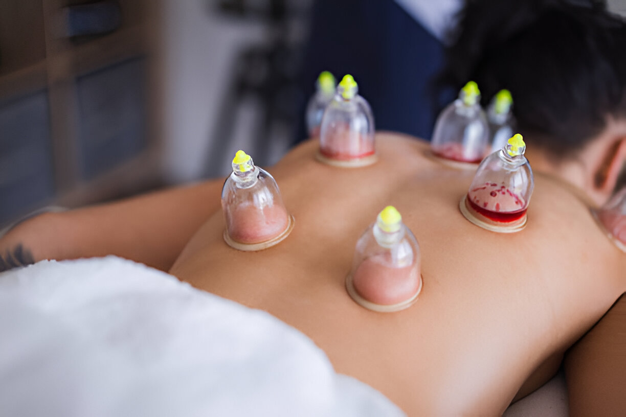 Tall slender porcelain bottle with natural clay textured body and cork stopper.