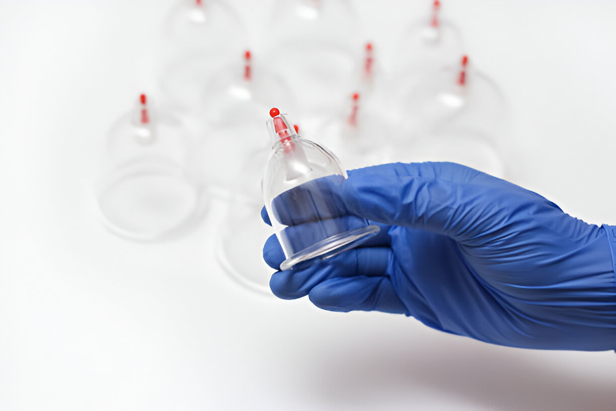 Hand holding black machined steel mechanical pencil with brass tip and top.