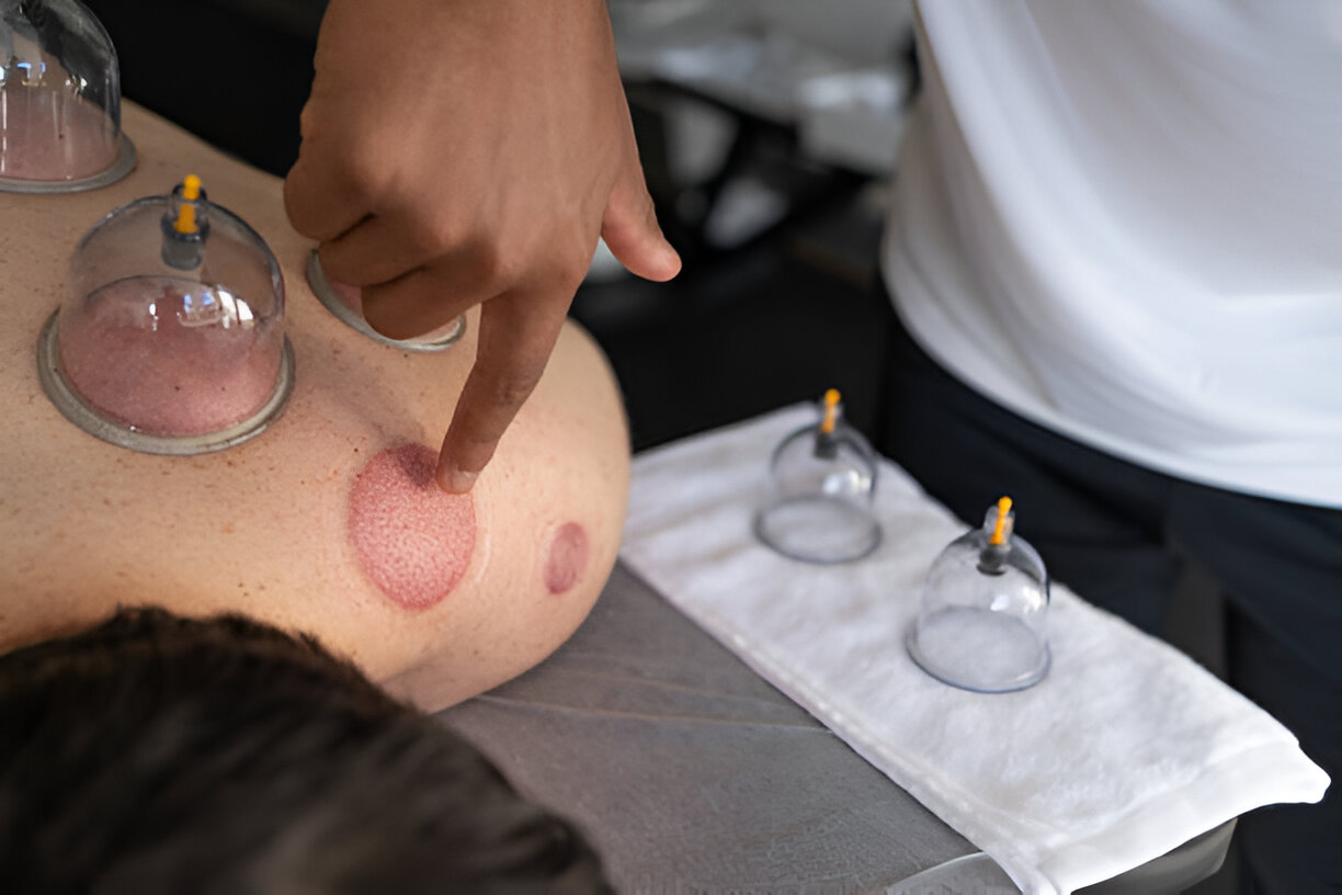 Person using a pen to cross a task off a productivity paper card.