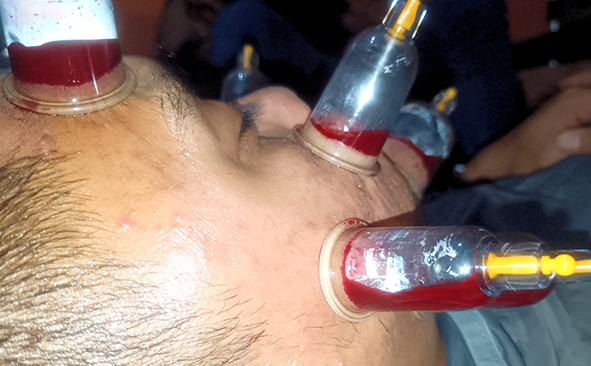 Person using a pen to cross a task off a productivity paper card.