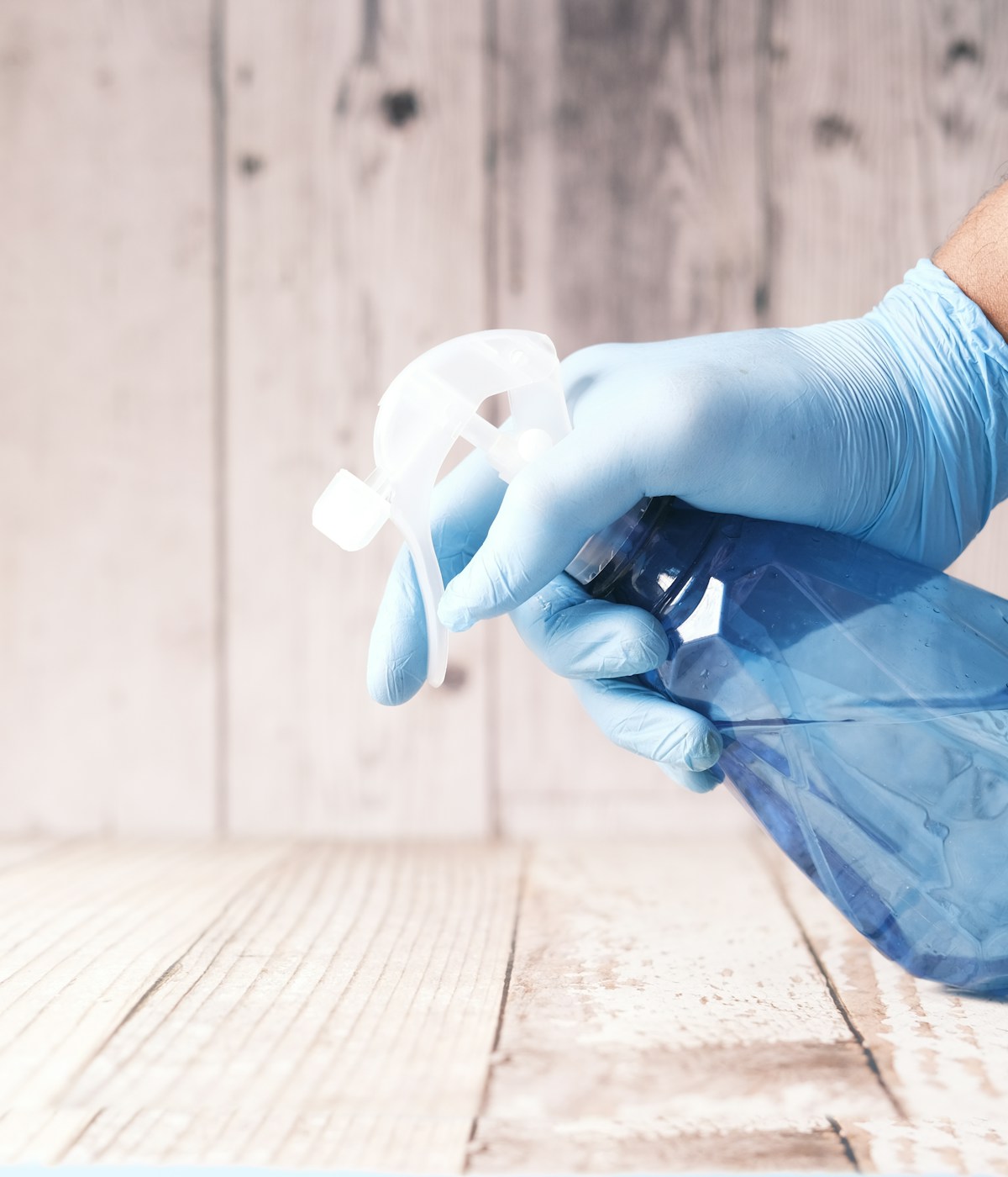 hand holding a cleaning detergent