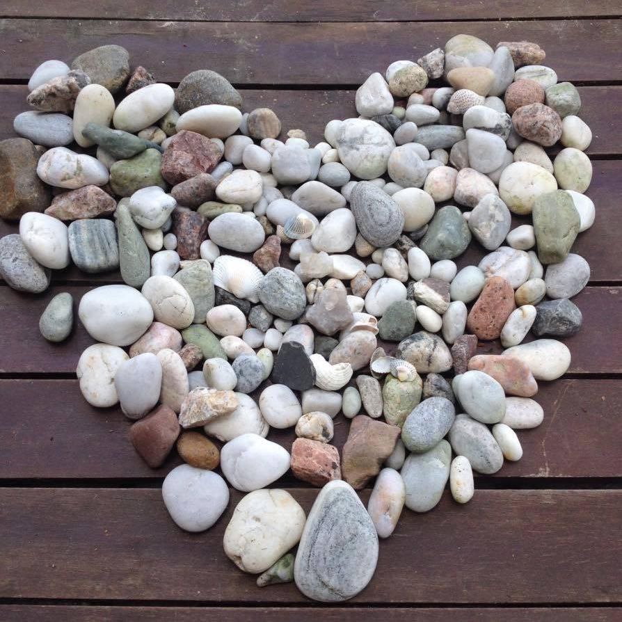 Tall slender porcelain bottle with natural clay textured body and cork stopper.