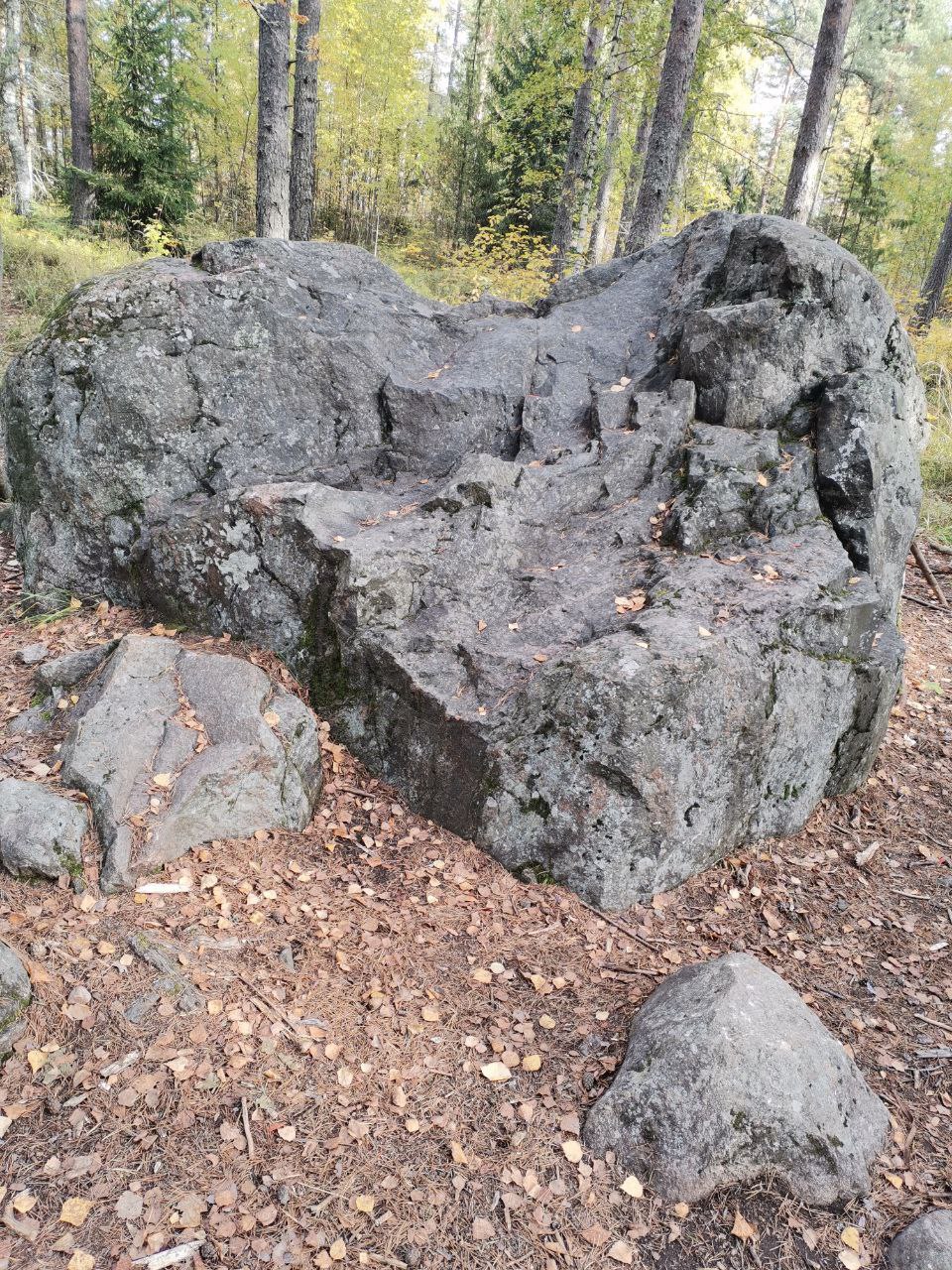 Person using a pen to cross a task off a productivity paper card.